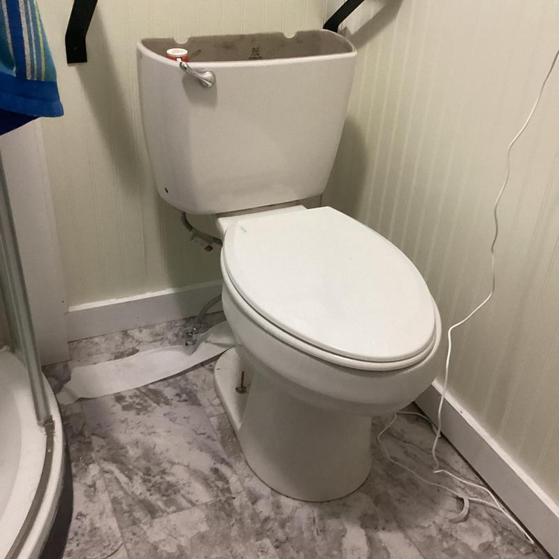 Toilet tank with replaced fill valve and flapper parts Toilet tank with replaced fill valve and flapper parts