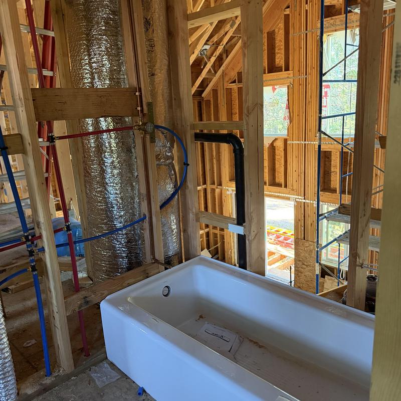 Cast-iron bathtub rough-in plumbing in framed bathroom Cast-iron bathtub rough-in plumbing in framed bathroom