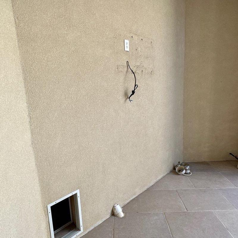 Stucco wall with patched fixture holes and wiring Stucco wall with patched fixture holes and wiring