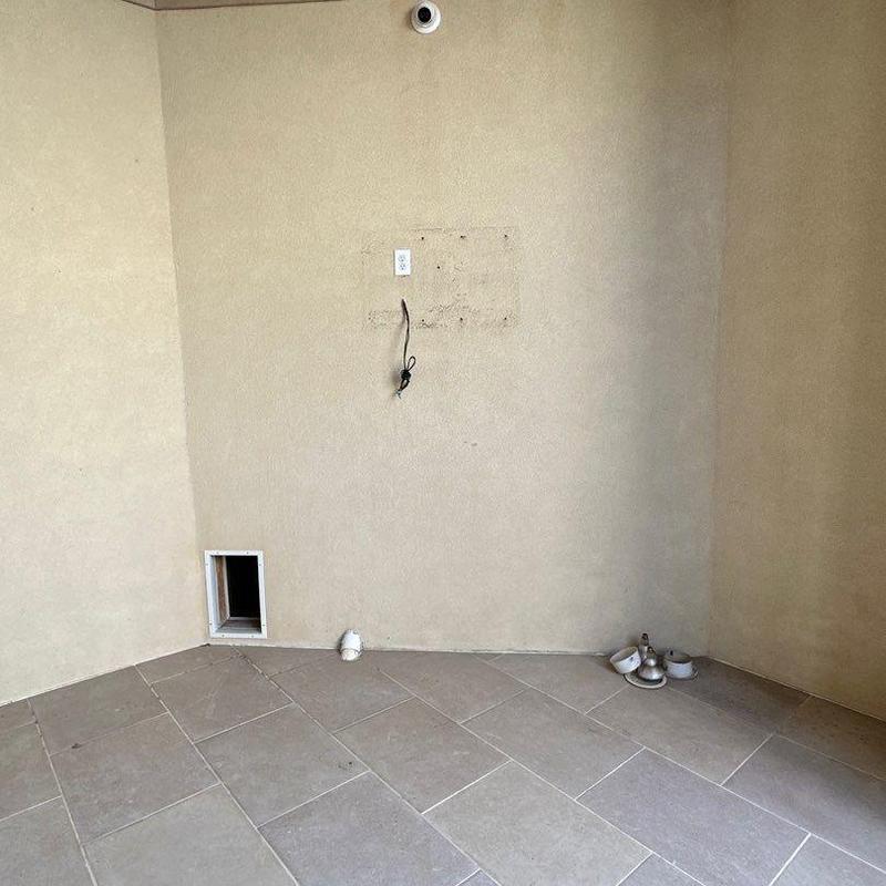Stucco wall patching with removed fixture areas on patio Stucco wall patching with removed fixture areas on patio