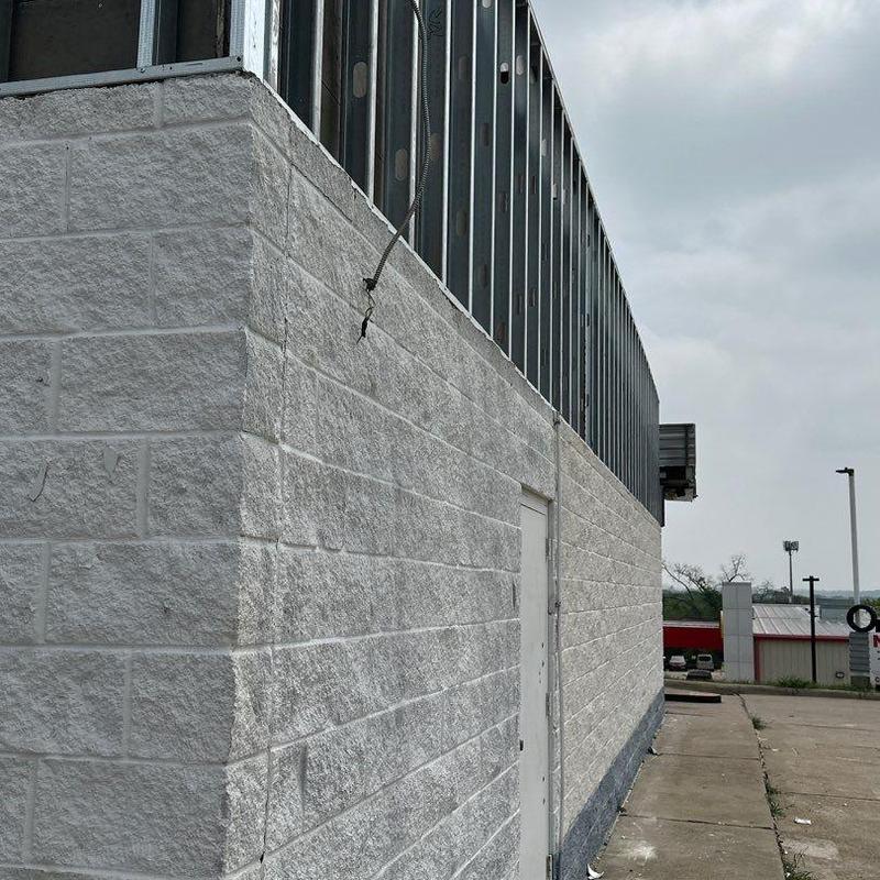 Concrete block wall exterior with metal framing Concrete block wall exterior with metal framing