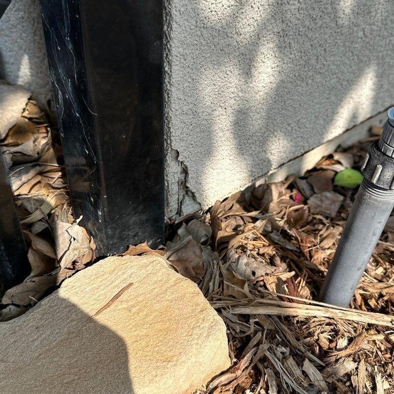 Stucco crack near window trim and downspout repair Stucco crack near window trim and downspout repair
