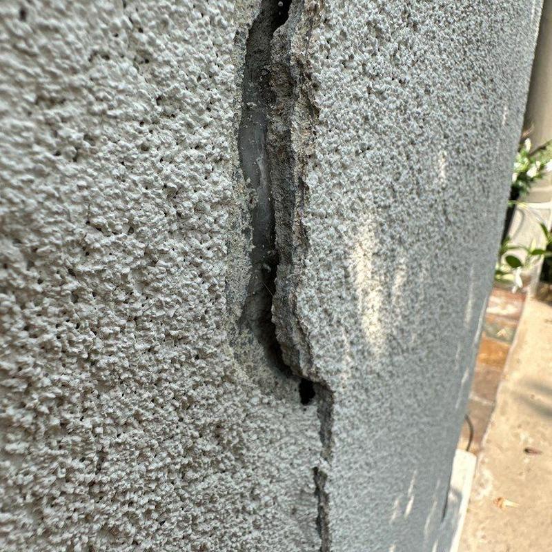 Stucco wall crack close-up showing damage and texture Stucco wall crack close-up showing damage and texture