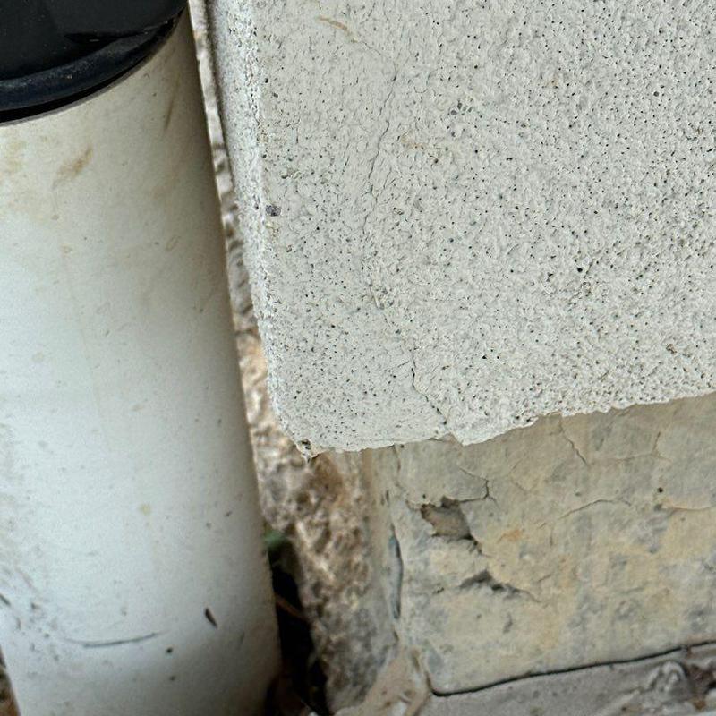 Stucco cracks near downspout and window trim Stucco cracks near downspout and window trim