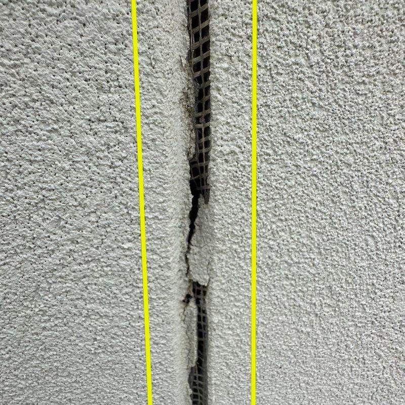 Stucco wall crack with exposed mesh close-up Stucco wall crack with exposed mesh close-up
