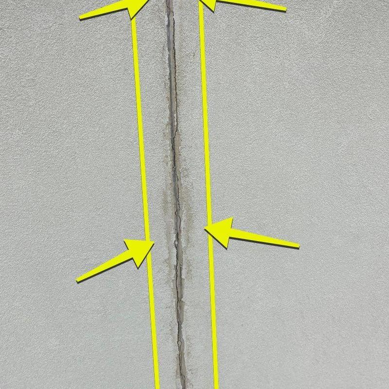 Stucco panel vertical crack with exposed mesh Stucco panel vertical crack with exposed mesh