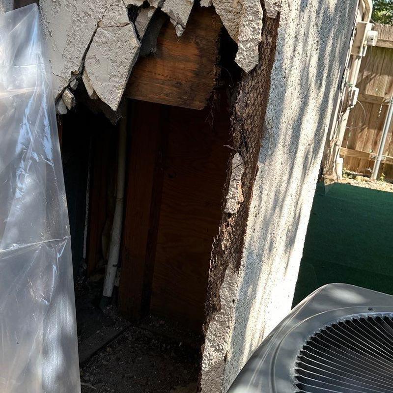 Stucco wall damage exposing wooden framing and lath Stucco wall damage exposing wooden framing and lath