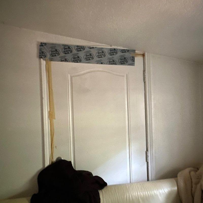 Interior door frame with taped wall damage repairs Interior door frame with taped wall damage repairs