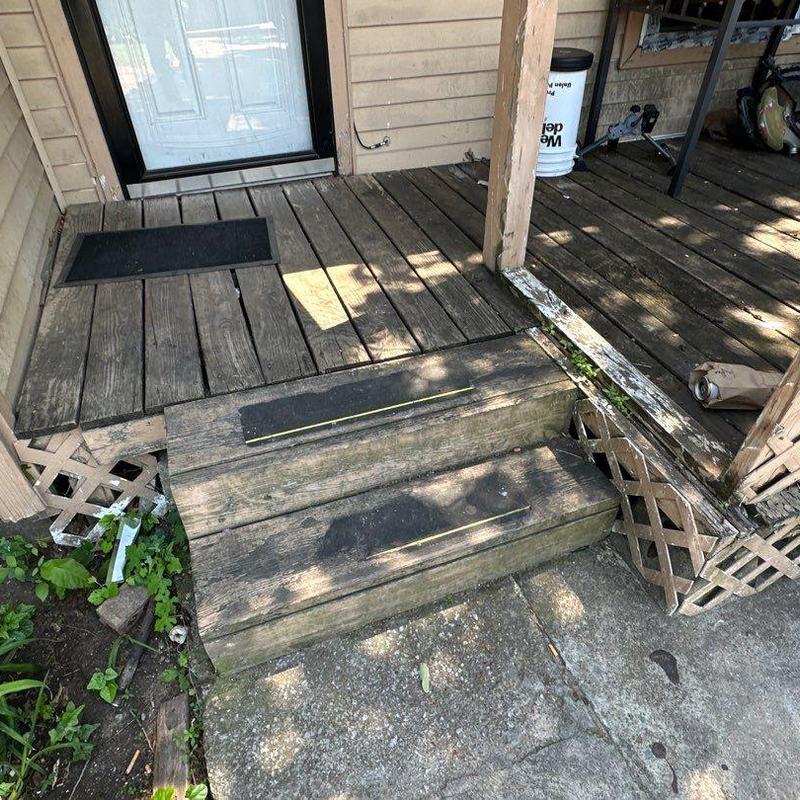 Wooden porch steps and deck with weathering damage Wooden porch steps and deck with weathering damage