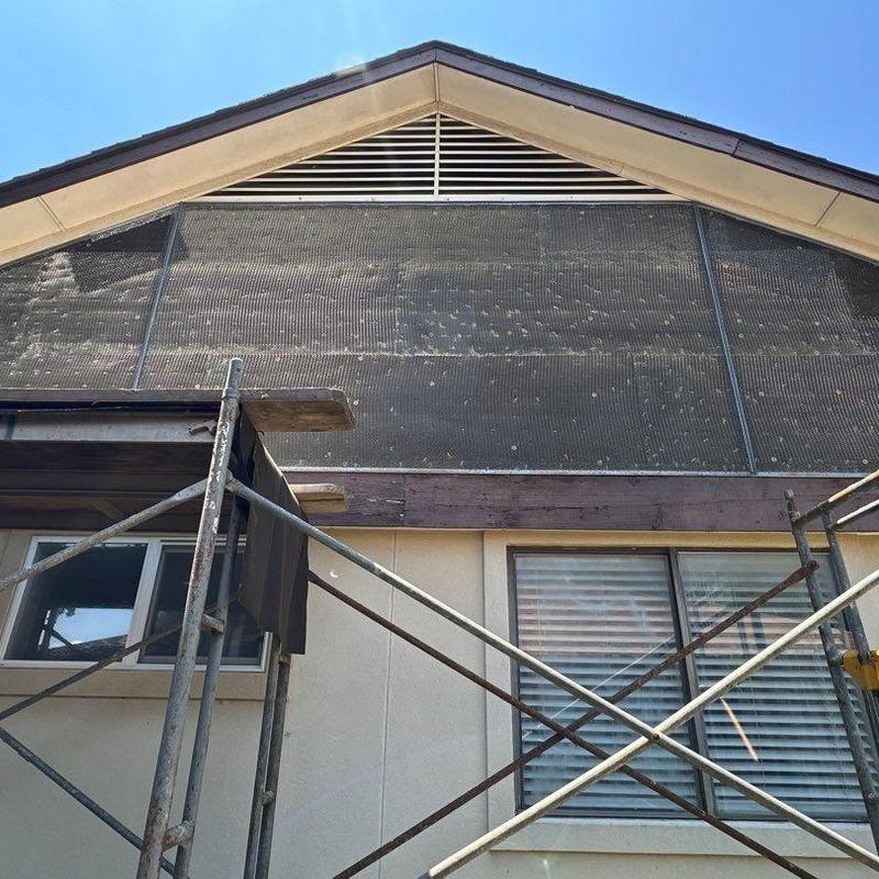 Stucco lath installation on upper gable with scaffolding Stucco lath installation on upper gable with scaffolding