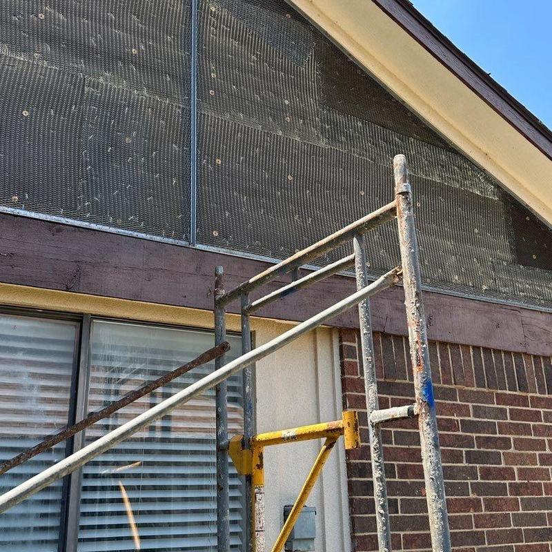 Stucco lath installation on upper gable with scaffolding Stucco lath installation on upper gable with scaffolding