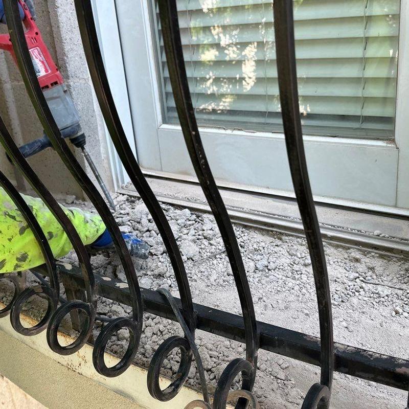 Concrete balcony edge with iron railing repair work Concrete balcony edge with iron railing repair work