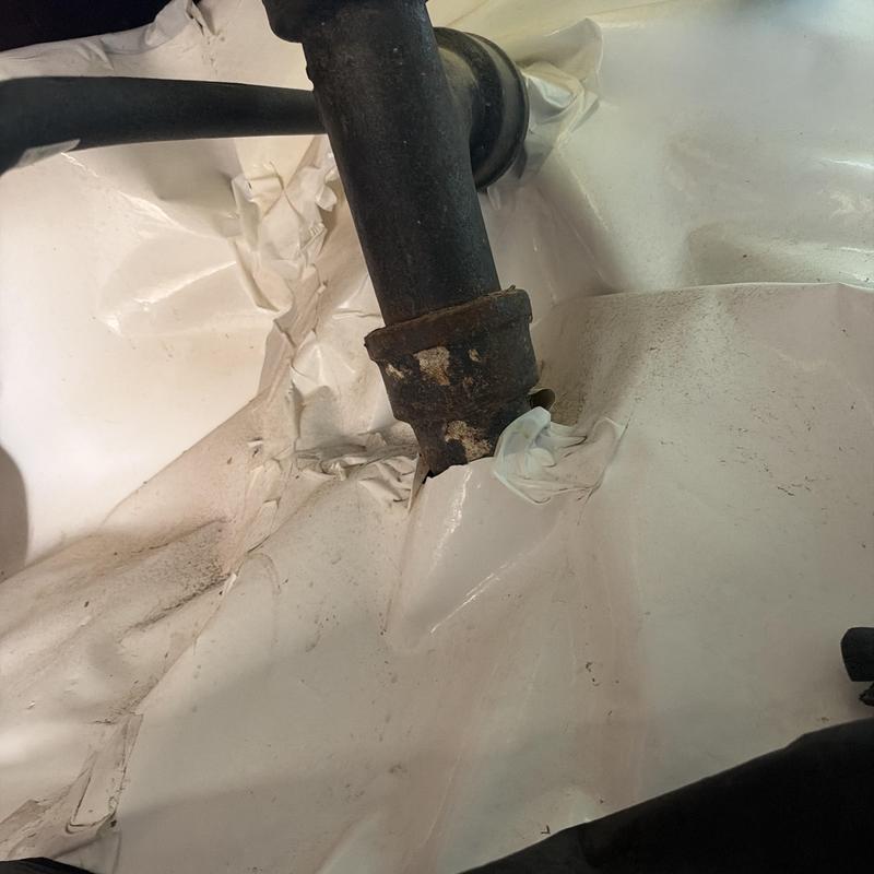 Cast iron drain pipe with plastic liner around base