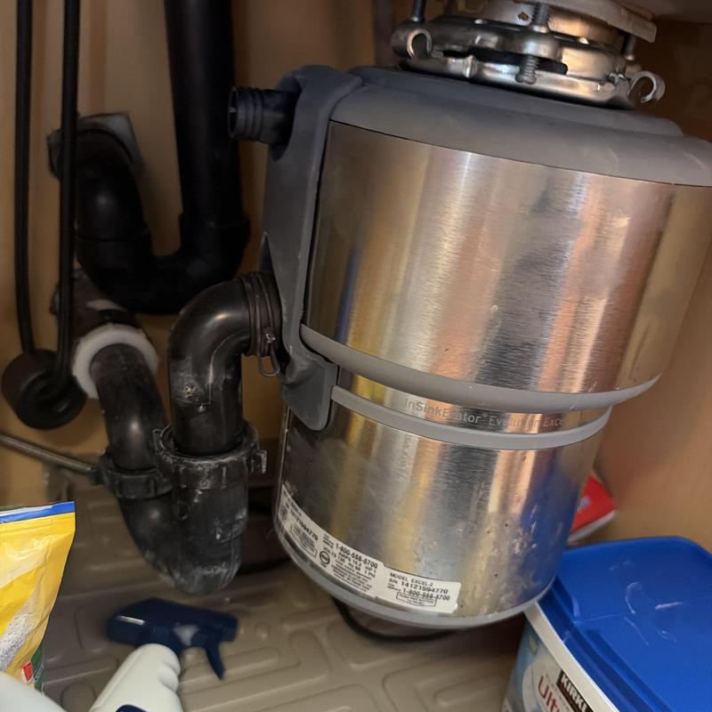 Garbage disposal with connected drain pipes under sink