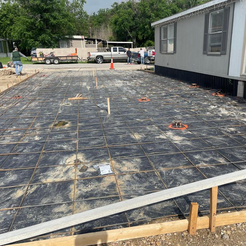 Concrete driveway steel reinforcement and plastic sheeting setup Concrete driveway steel reinforcement and plastic sheeting setup