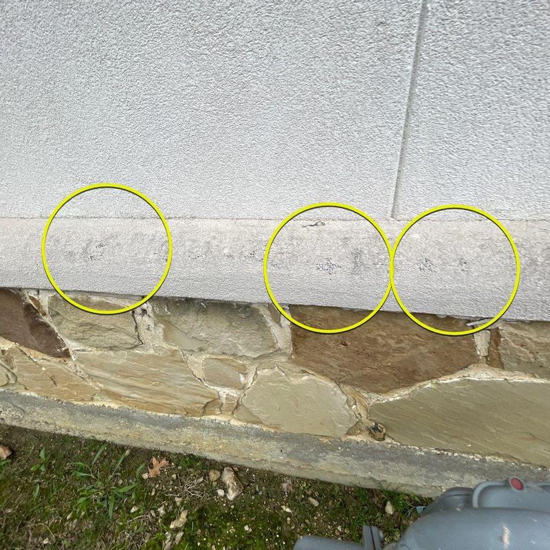 Stucco damage along stone veneer lower wall corner Stucco damage along stone veneer lower wall corner