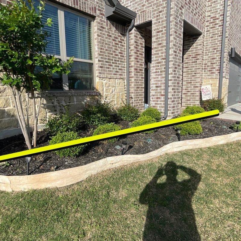 Concrete garden bed edging beside brick house exterior Concrete garden bed edging beside brick house exterior