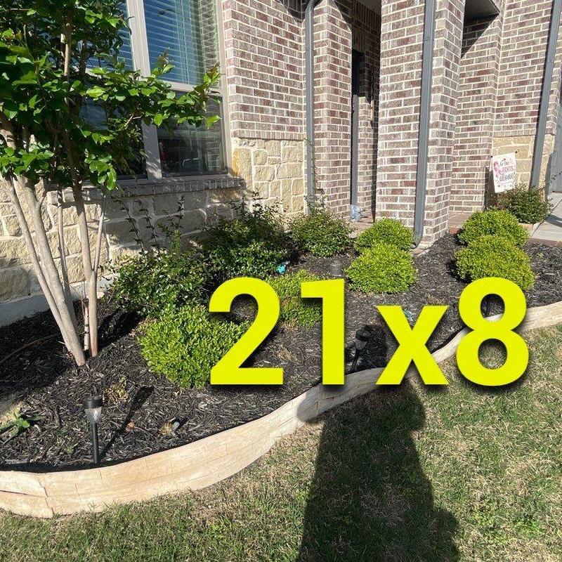 Concrete landscape edging beside brick and stone home Concrete landscape edging beside brick and stone home