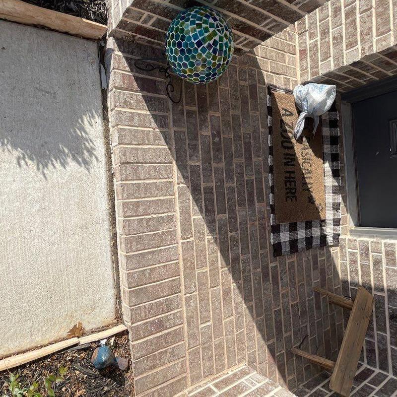 Concrete walkway repair beside brick entry porch Concrete walkway repair beside brick entry porch