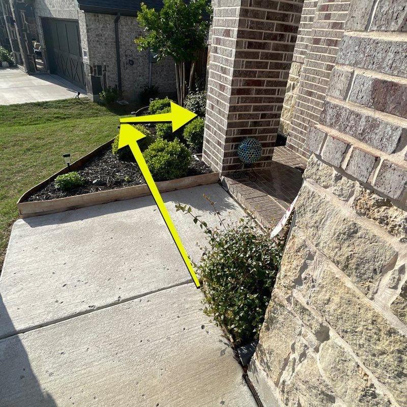 Concrete front entry walkway beside landscaping bed Concrete front entry walkway beside landscaping bed