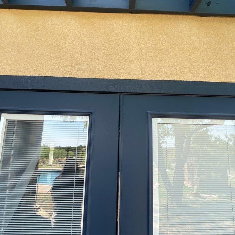 Stucco exterior crack and damaged wall base near door Stucco exterior crack and damaged wall base near door
