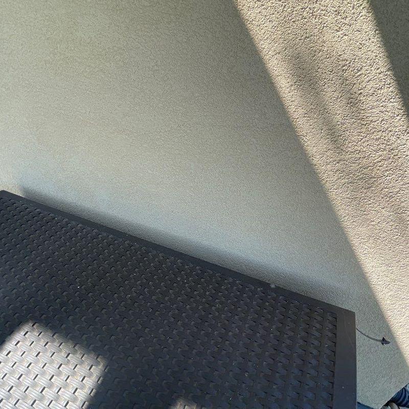 Stucco exterior wall with textured finish and shadows Stucco exterior wall with textured finish and shadows