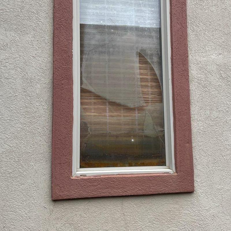 Stucco window frame with cracked and peeling paint Stucco window frame with cracked and peeling paint