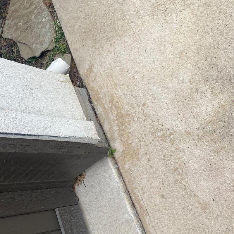 Stucco corner damage and sidewalk gap at home exterior Stucco corner damage and sidewalk gap at home exterior