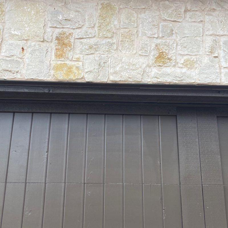 Stucco exterior with stone above garage door panels Stucco exterior with stone above garage door panels