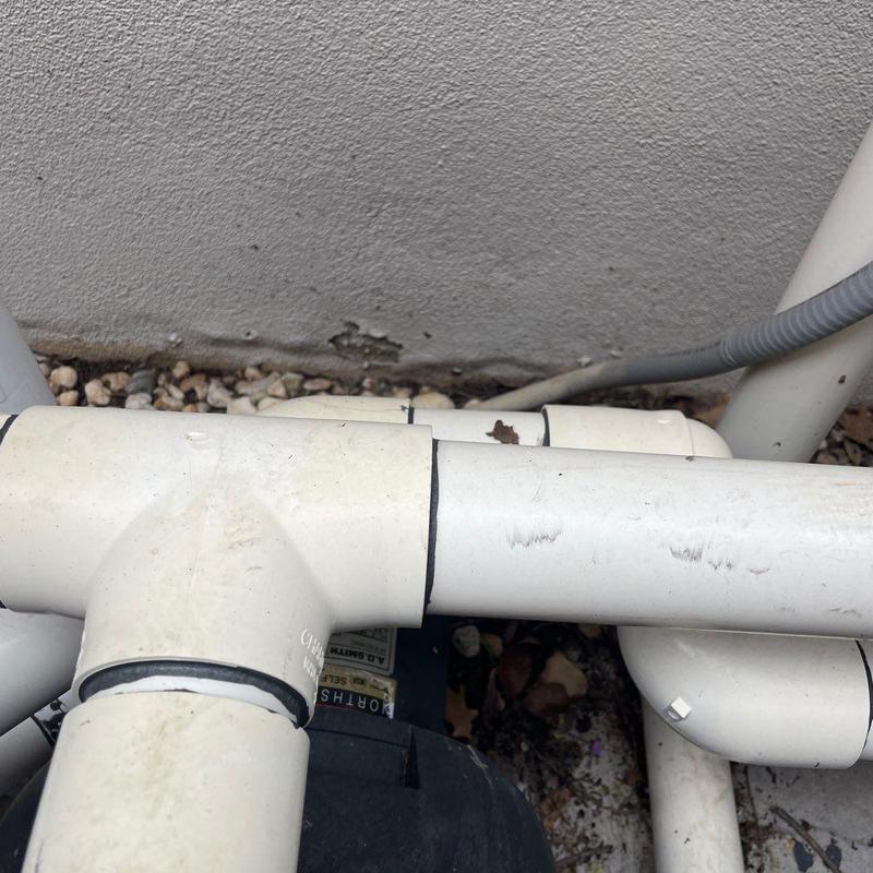 PVC pipe joint connection near stucco wall base PVC pipe joint connection near stucco wall base