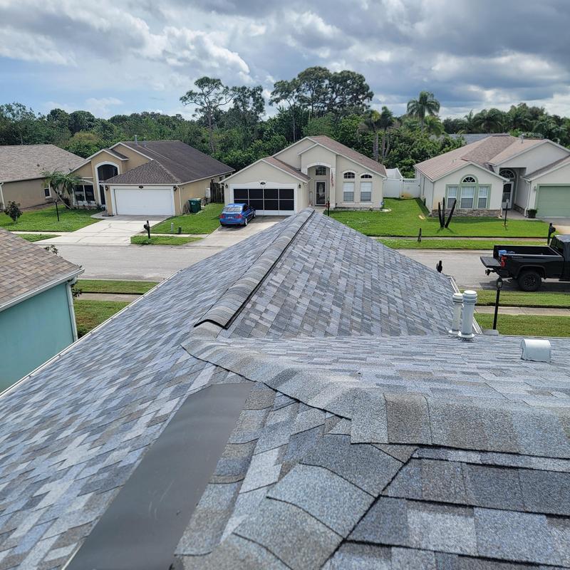 Asphalt shingle roof with ridge vent installation in neighborhood Asphalt shingle roof with ridge vent installation in neighborhood