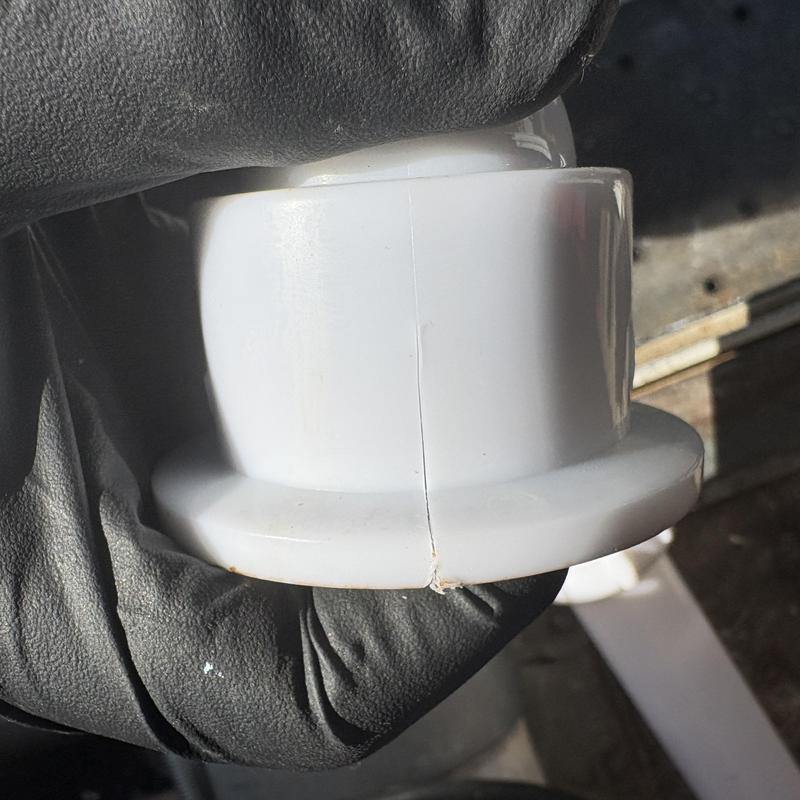 PVC tub waste flange with visible hairline crack