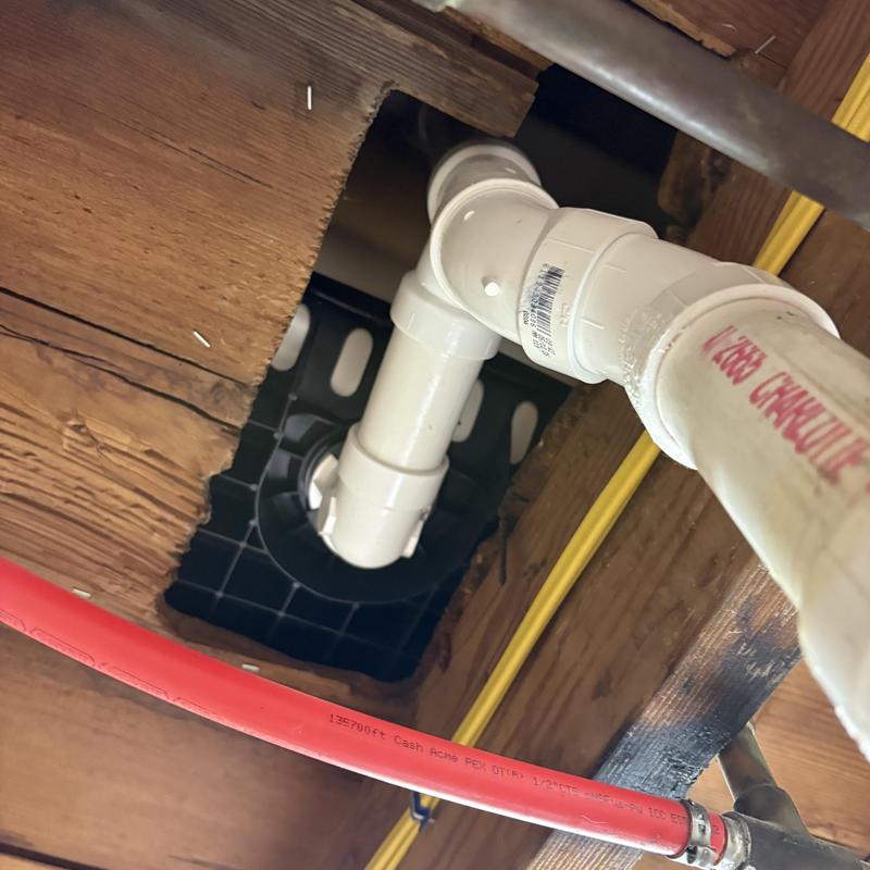 PVC tub waste pipe with welded fittings underneath floor