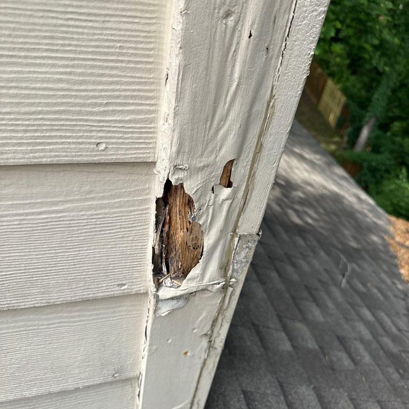 Wood siding corner with water damage and peeling paint