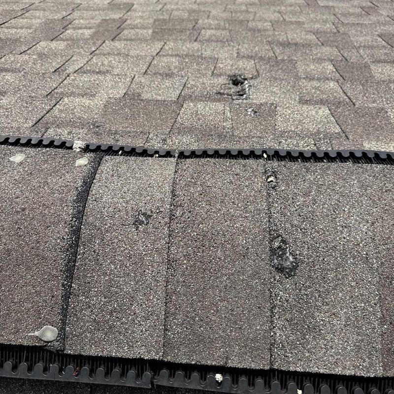 Asphalt roof shingles with hail damage and wear