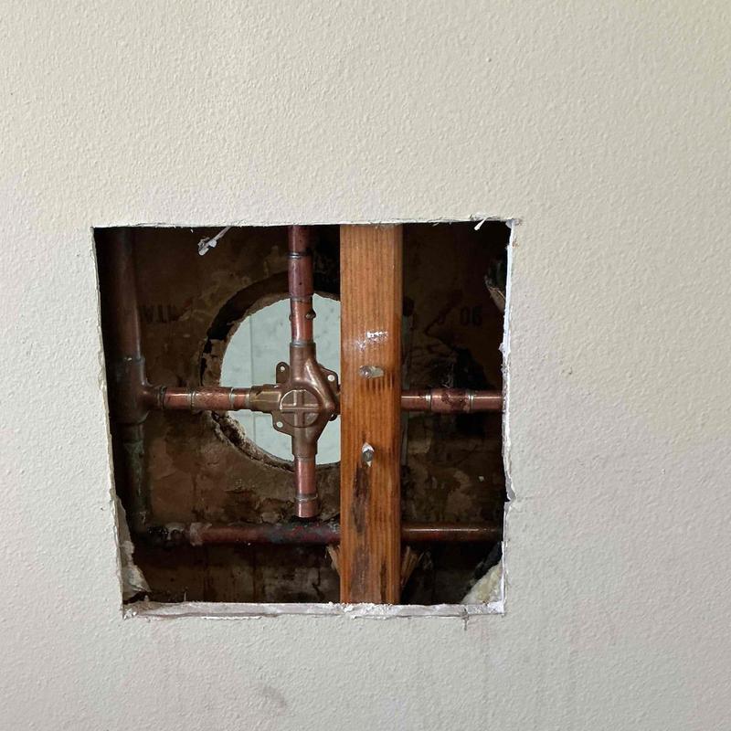 Master bathroom shower valve with copper piping exposed