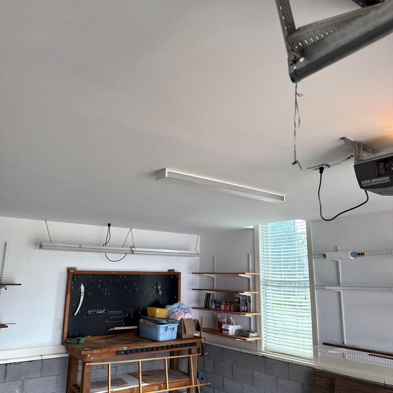 Garage shelving and workbench installation in natural light