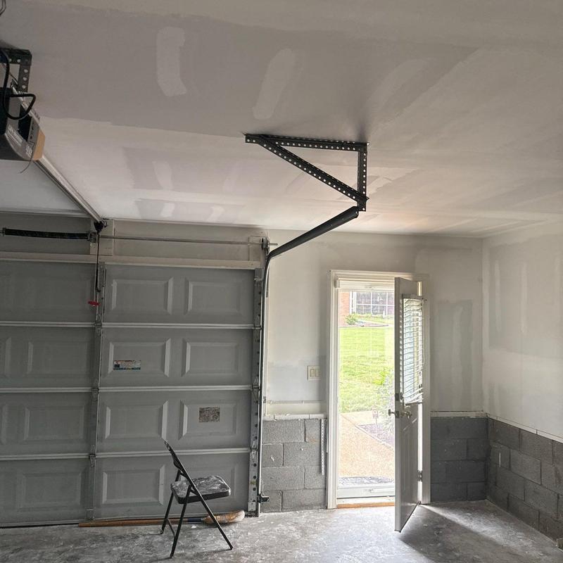 Garage door system and drywall repair in garage