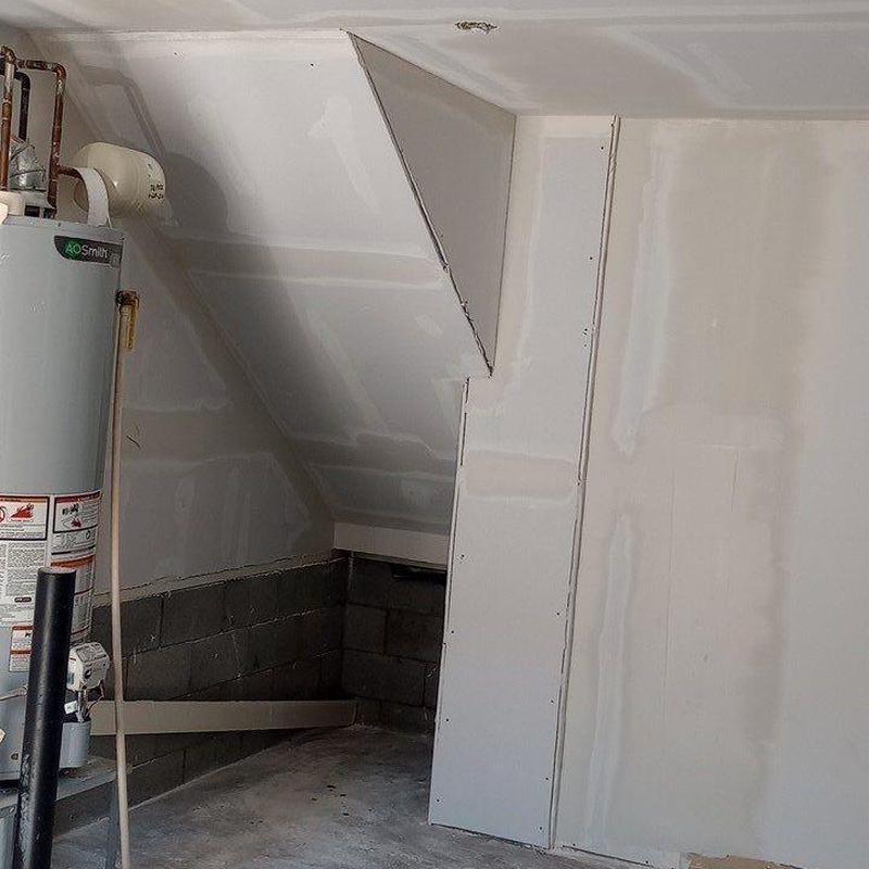 Drywall repair in garage near water heater