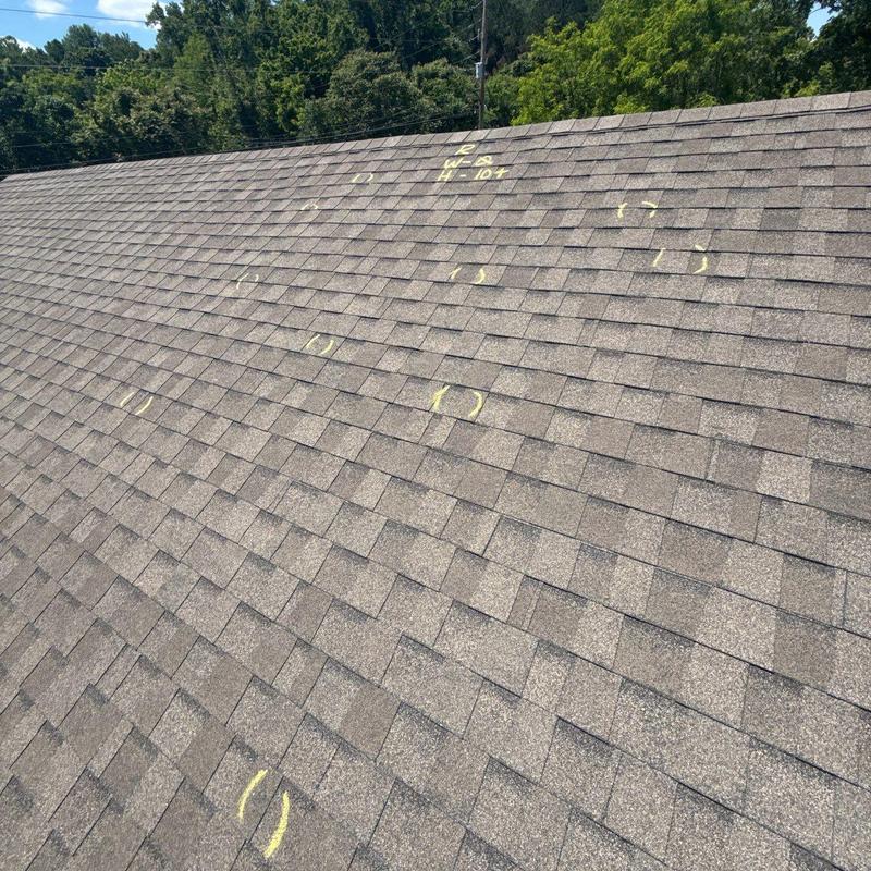 Asphalt shingle roof with hail damage markings
