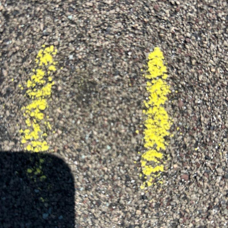 Asphalt shingle surface with yellow hail damage markings