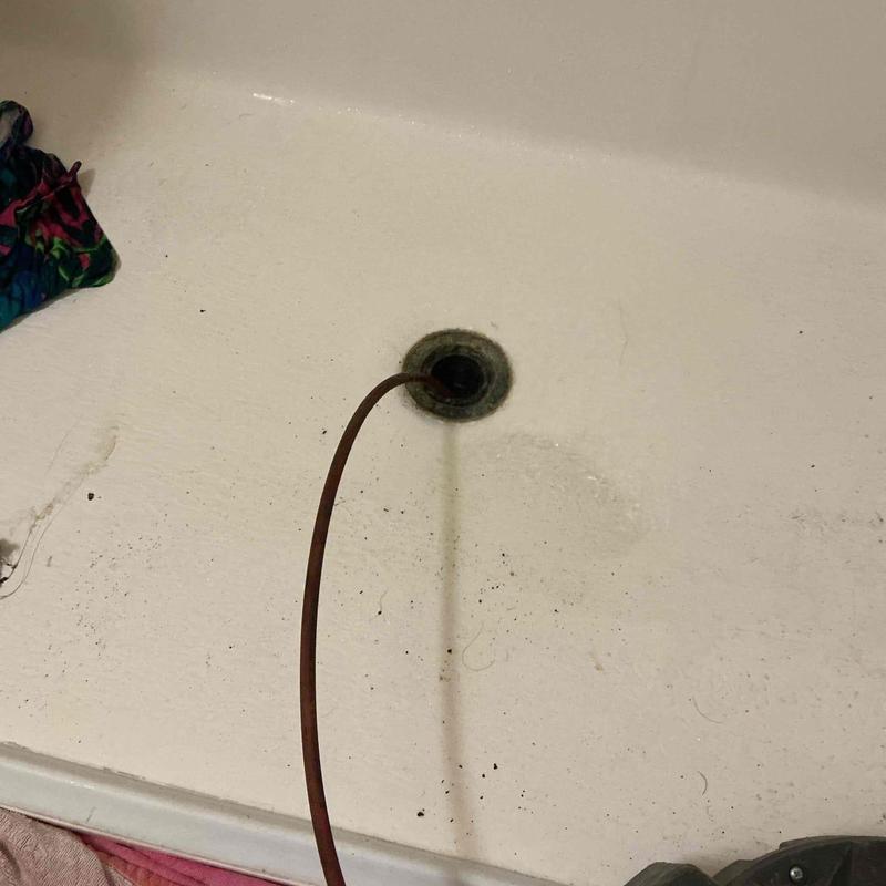 Shower drain with drain snake clearing blockage