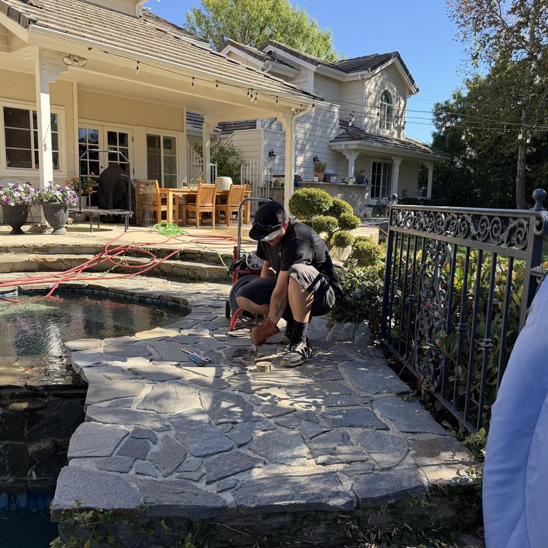 Pool deck stone repair with tools and technician Pool deck stone repair with tools and technician