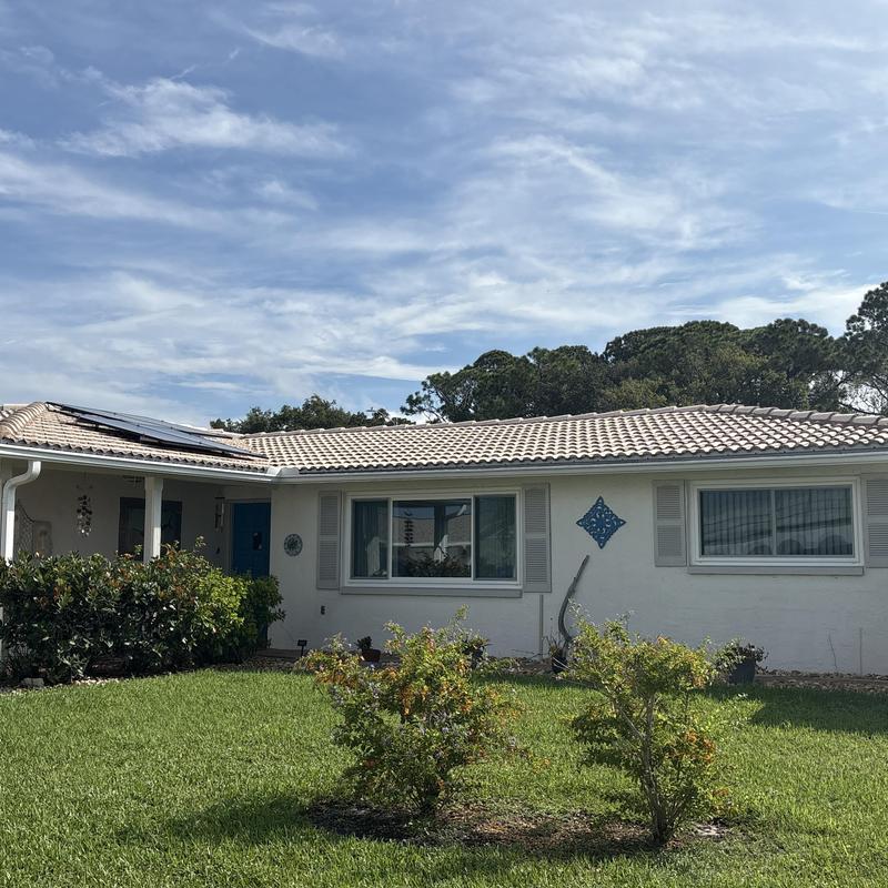 Tile roof with solar panels on residential home Tile roof with solar panels on residential home
