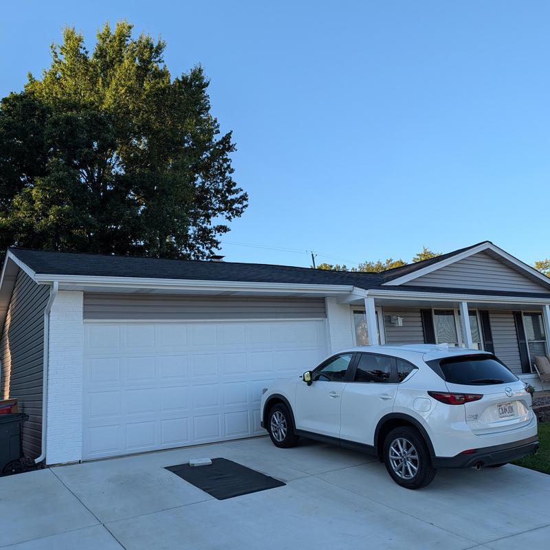 Garage door and siding with new gutters in Fenton, MO