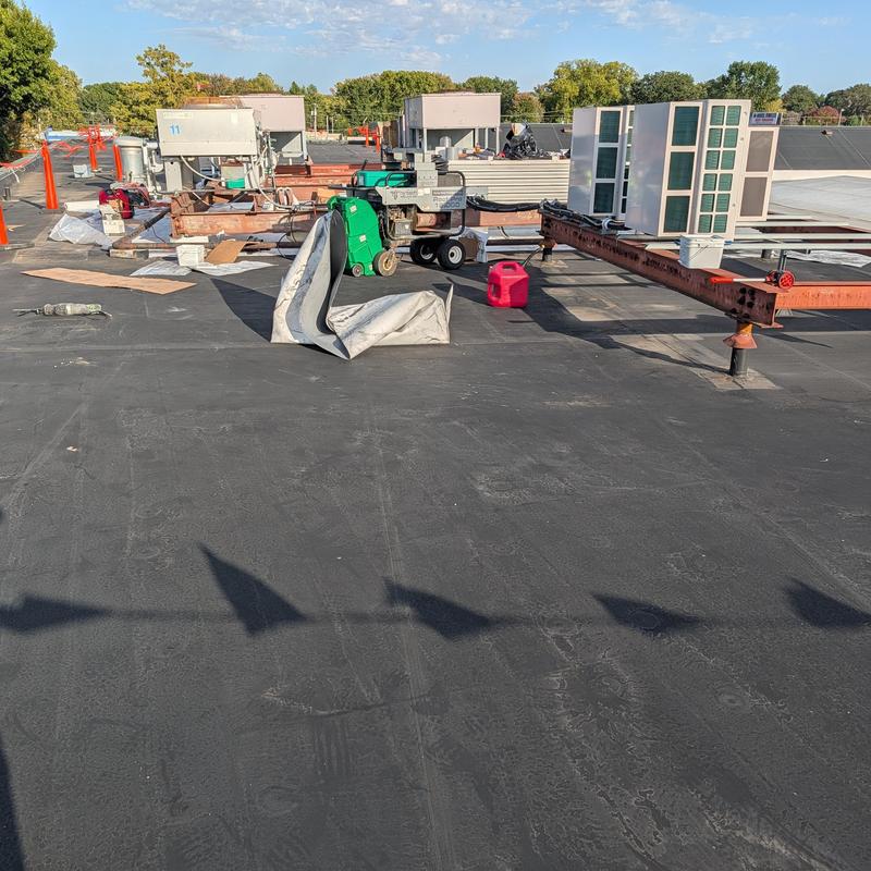 Rubber roofing membrane with HVAC units and tools