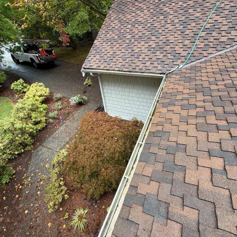 Roof gutter with hose cleaning at residential home