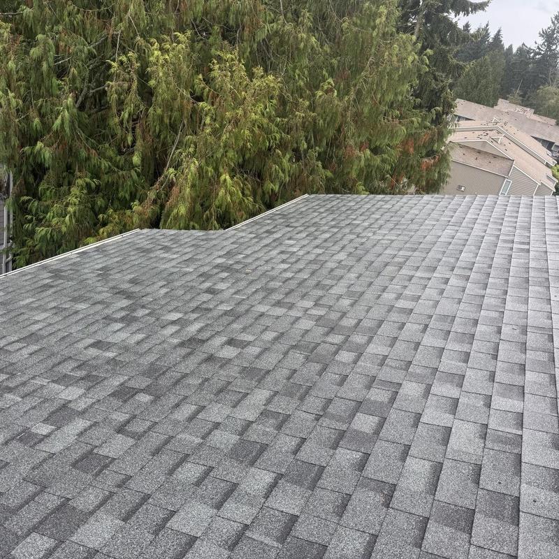 Architectural shingle roof with new gray shingles installed