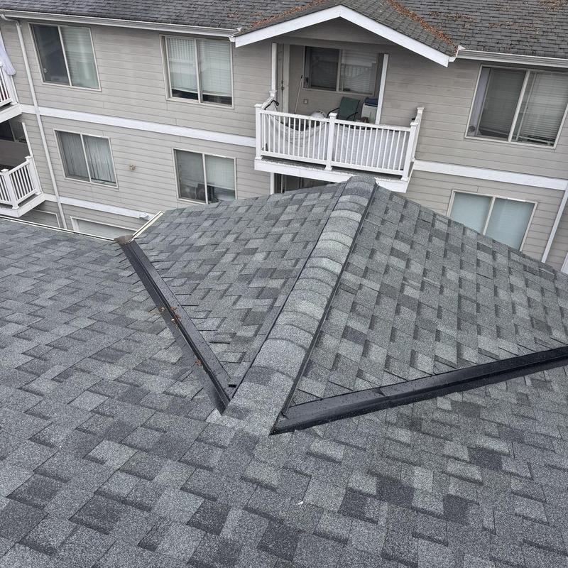 Asphalt shingle roof with ridge and valley flashing