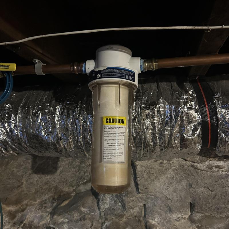 Whole house water filter housing installed in basement Whole house water filter housing installed in basement